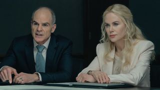 Byron and Kaitlyn look across a desk