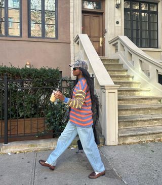 Influencer wears brown loafers.