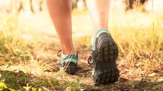 Best eco-friendly running shoes: Pictured here, a woman wearing running shoes in forest