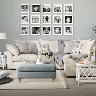 living room with family photos lamp and sofa set with cushion