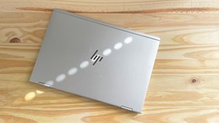 A 2017 HP EliteBook x360 1030 G2 seen from above on a wood table