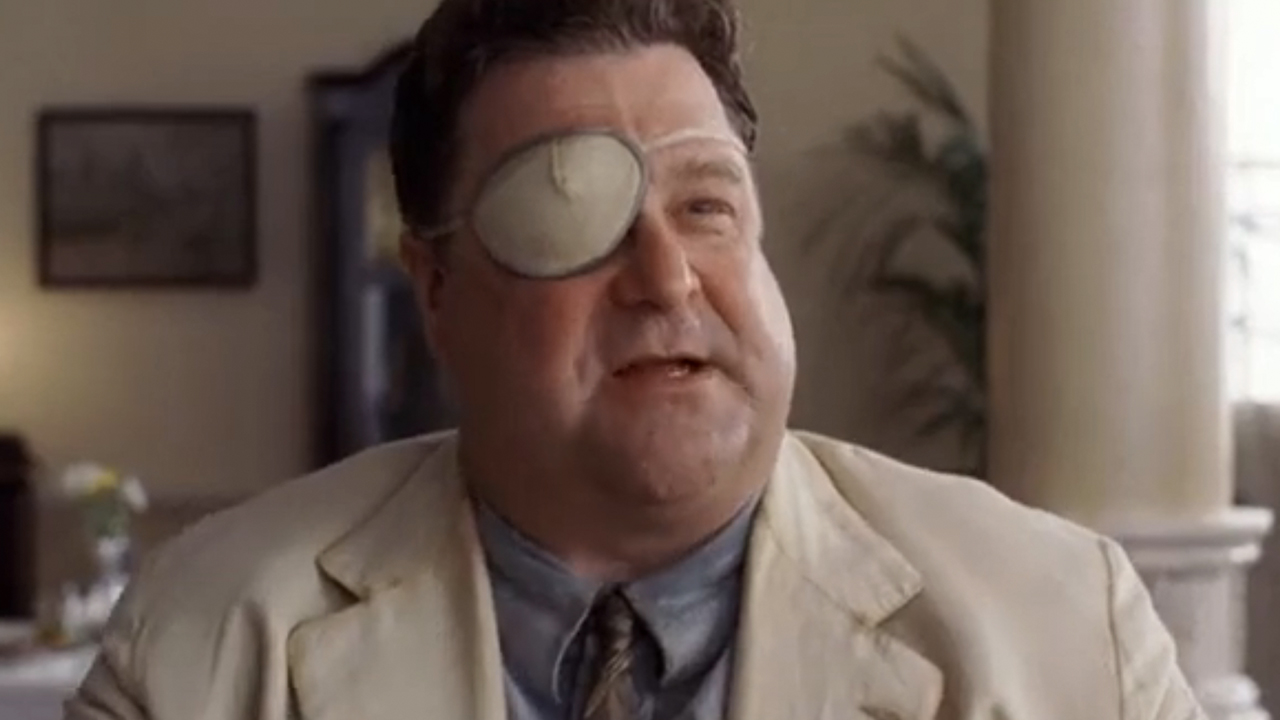 John Goodman wearing an eye patch and a suit in O Brother Where Art Thou?