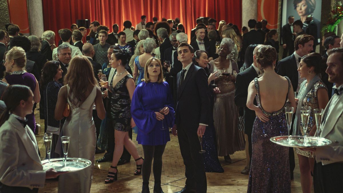 Lucy and Lockwood in the crowd at the ball in Lockwood &amp; Co.