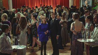 Lucy and Lockwood in the crowd at the ball in Lockwood & Co.