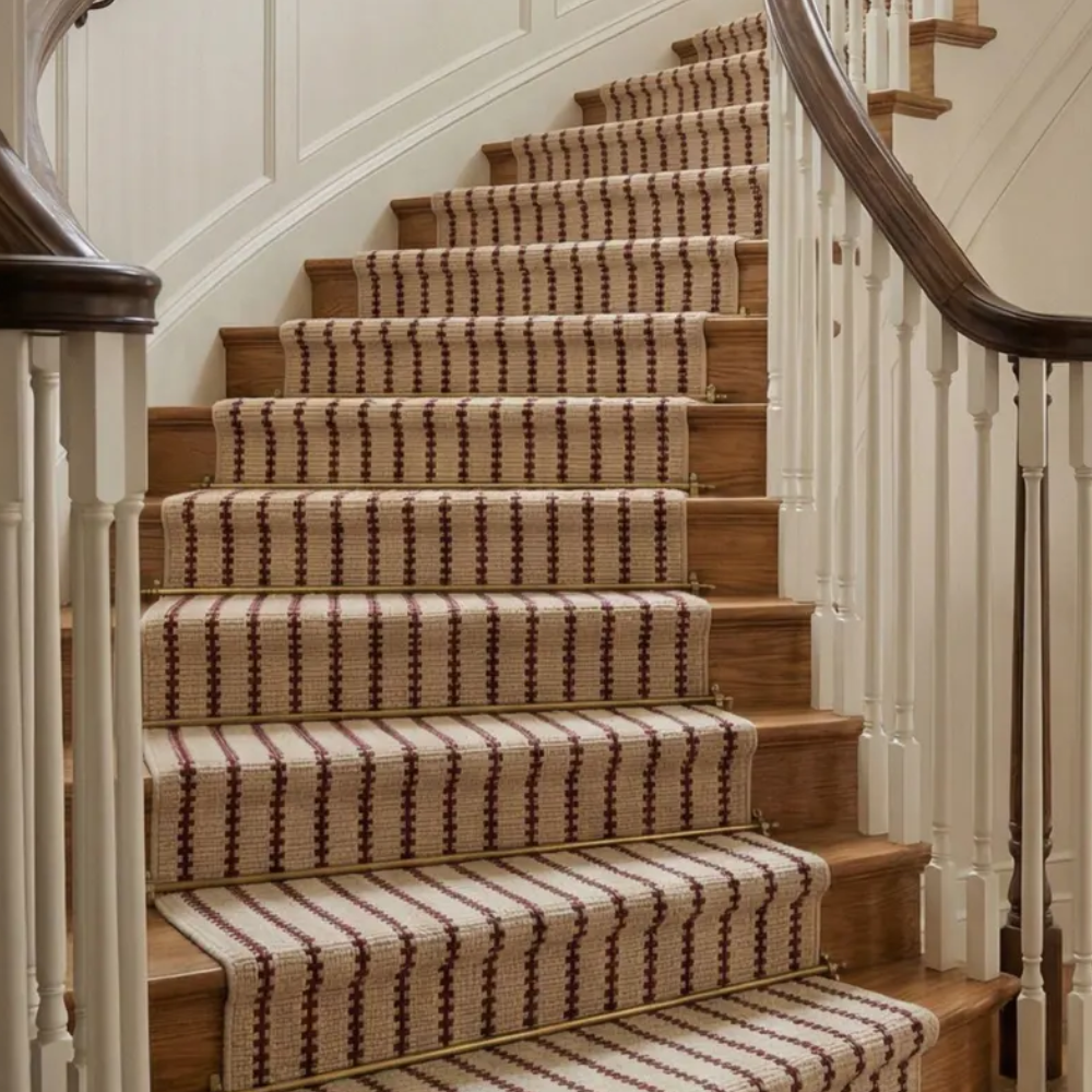 Red and cream stair runner on curved stair case
