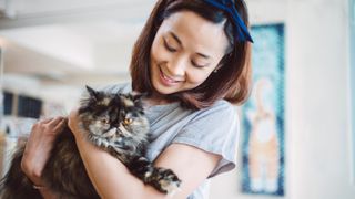 Woman cuddling cat