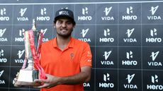 Eugenio Chacarra poses with the 2025 Hero Indian Open trophy after winning by two strokes on the DP World Tour