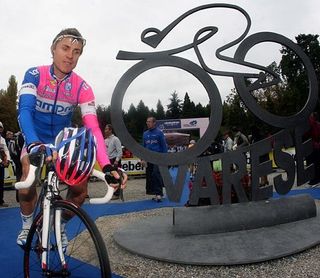 Cunego rides by the bike statue.