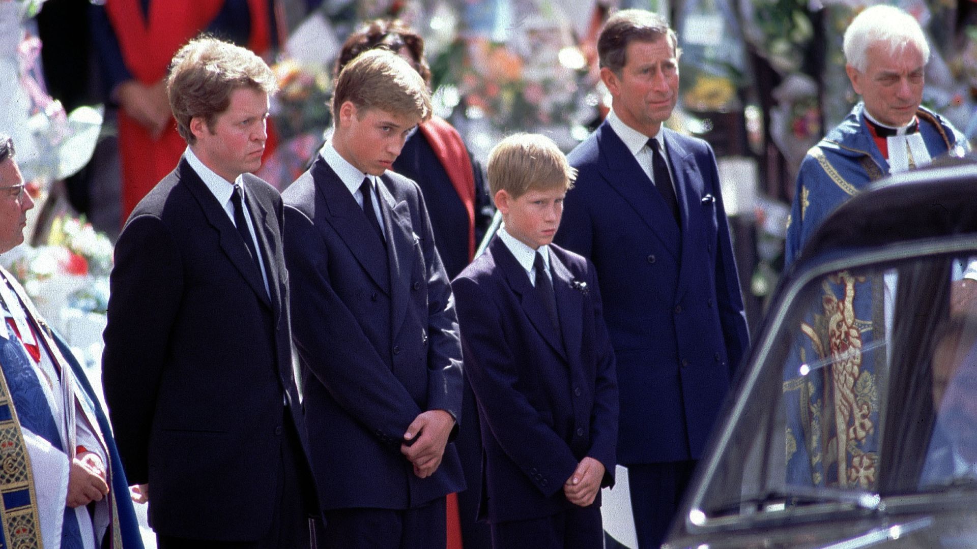 L-R: Earl Spencer, Prince William, Harry and King Charles stand alongside the hearse containing the Princess Diana's coffin after her funeral service at Westminster Abbey