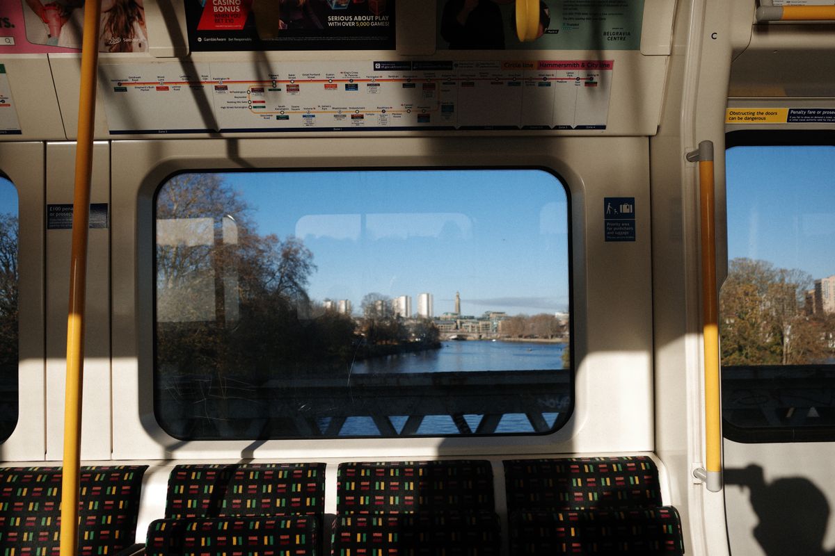 View out of the window on a London tube train of a river with tall buildings in the background