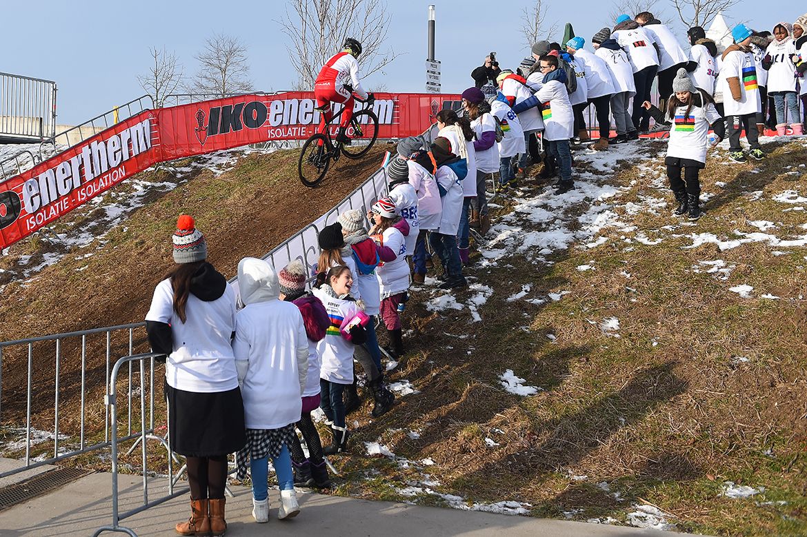 The kids watch the riders take on the tricky parts of the Bieles course