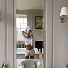 Woman taking a mirror selfie in her bathroom