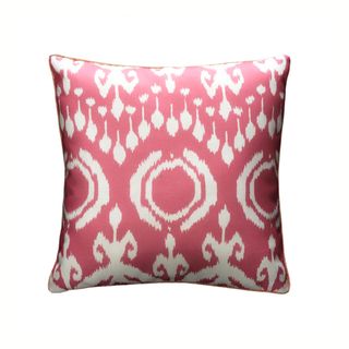 A pink and white Ikat outdoor cushion