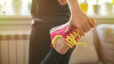 Woman stretching with a workout shoe