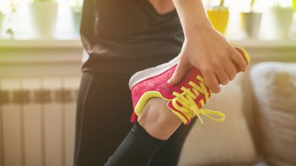 Woman stretching with a workout shoe