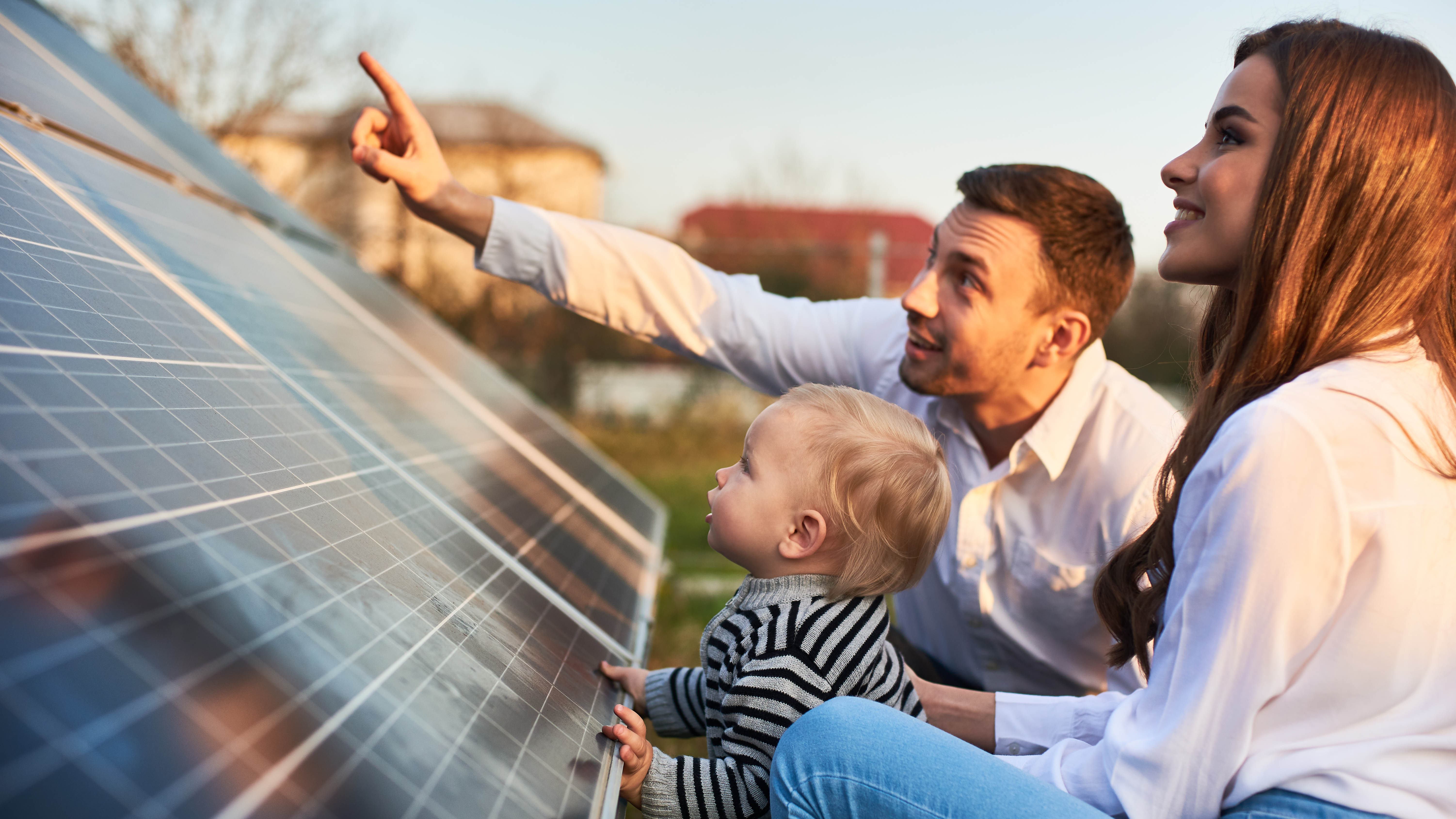 A family looking at a solar panel