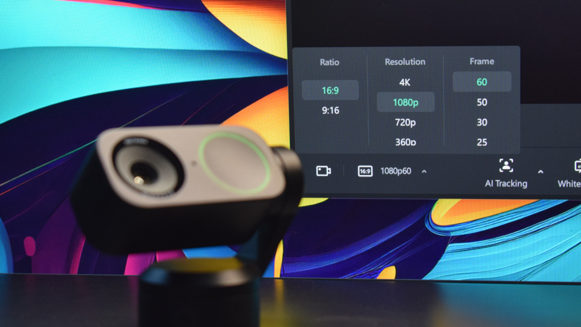Photo of the Insta360 Link 2 4k webcam showing the Insta360 Link Controller software in the background depicting each of the camera's image ratio, resolution, and frame rate options.