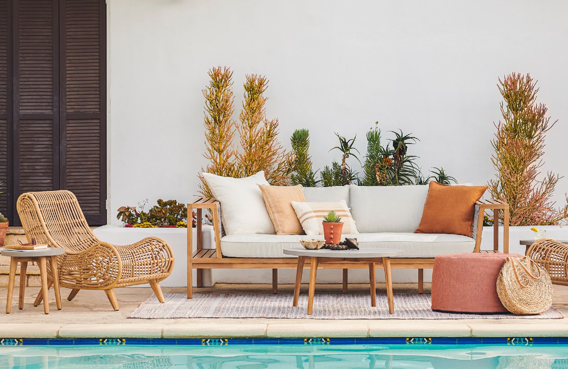 An outdoor sofa and wicker lounge chair