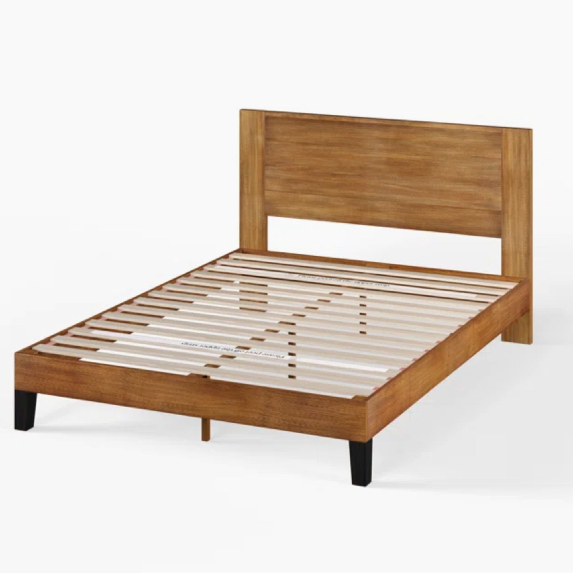A wooden bed frame with black legs