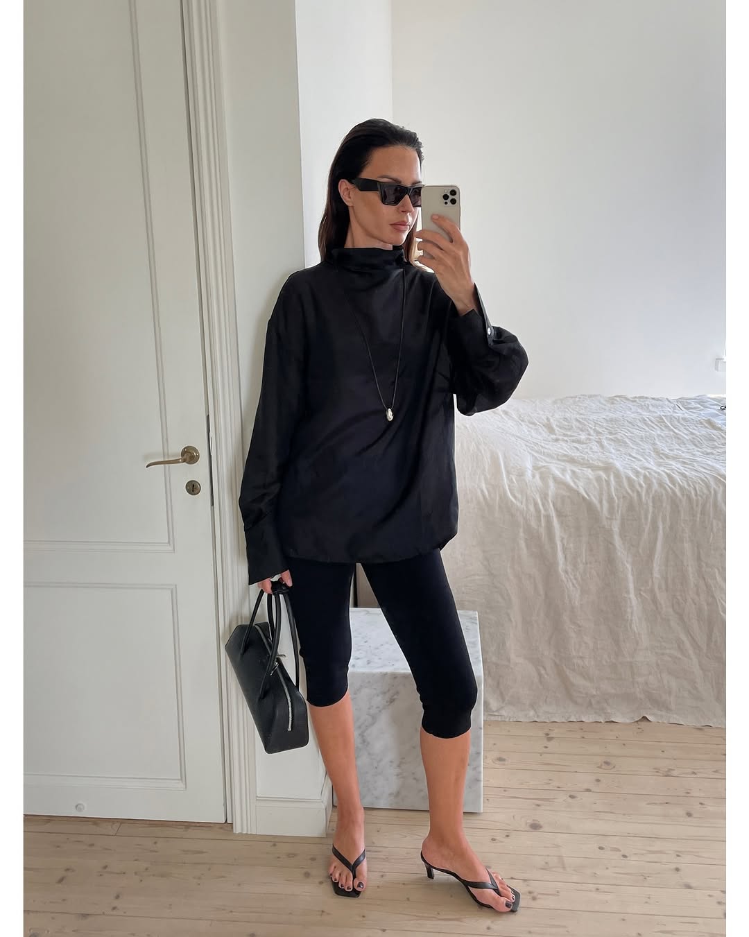 woman wearing black capri pants outfits 2025
