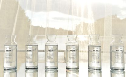 water in glass jars in a line