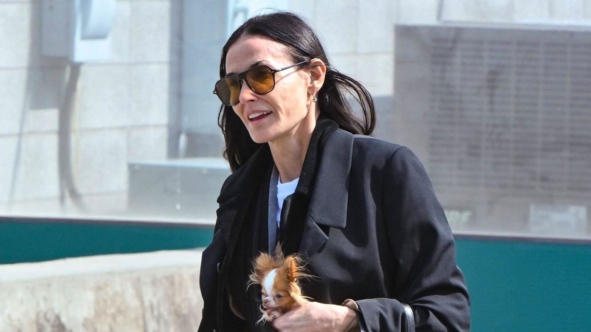 Demi Moore wearing a black blazer, jeans, and black derby shoes