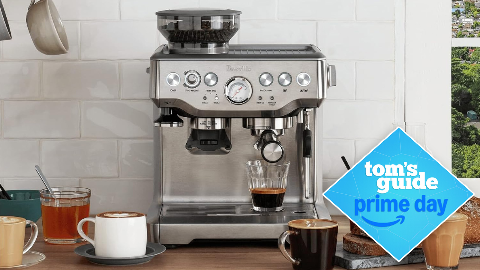 the breville barista express espresso machine in silver with cups of coffee surrounding it, with a blue diamond tom&#039;s guide deal badge on top