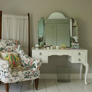 room with wooden flooring and dressing table and armchair