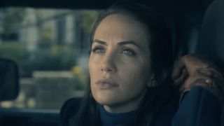 Theo wearing gloves in the car watching a man's arrest in The Haunting of Hill House.
