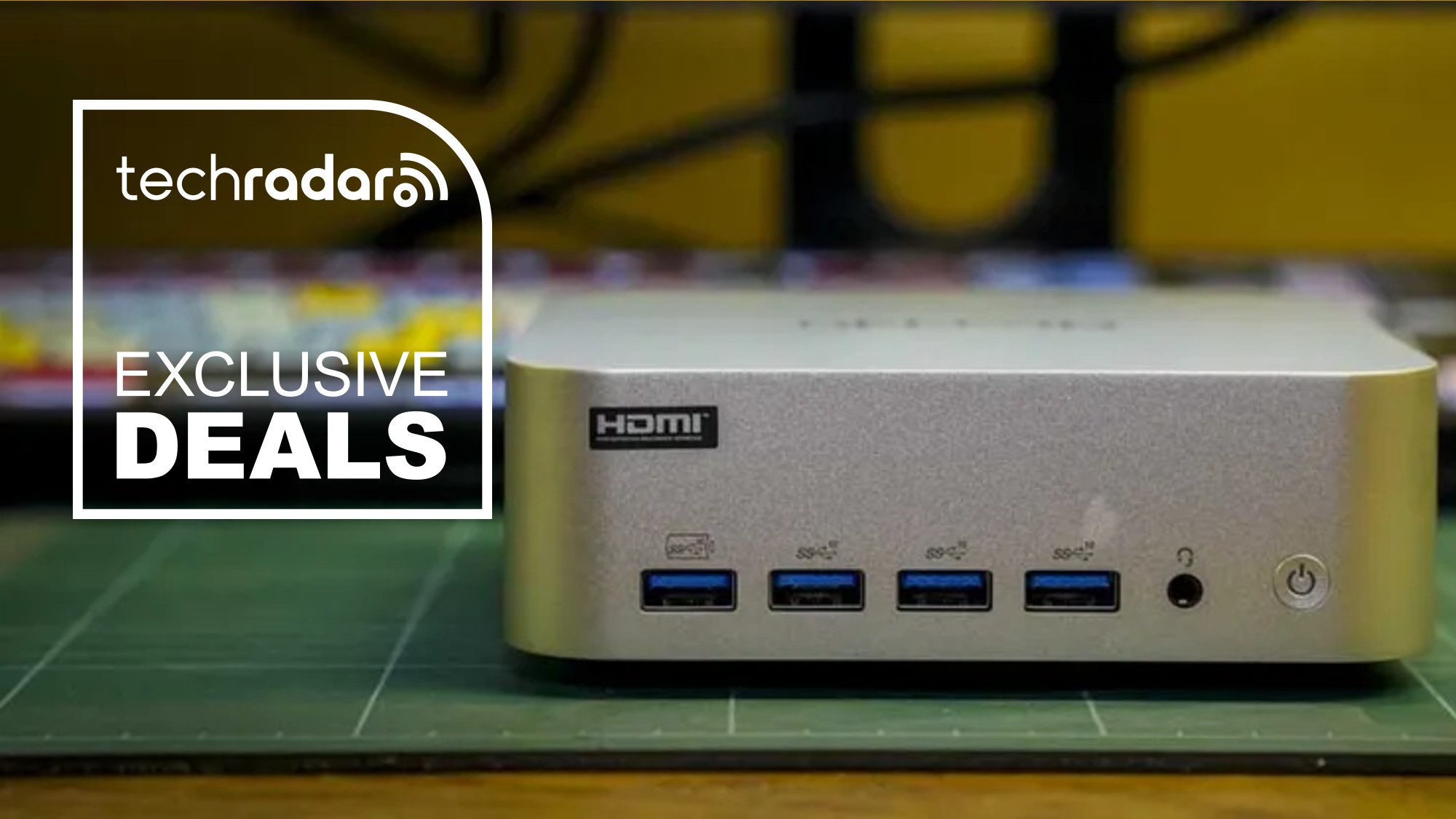 The Geekom A9 Max 2026 Edition on a work surface next to a TechRadar badge that reads 'Exclusive Deals'