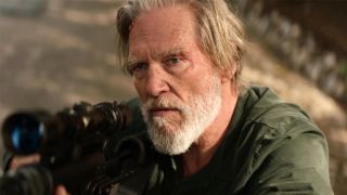 Jeff Bridges looking up from a sniper rifle in The Old Man