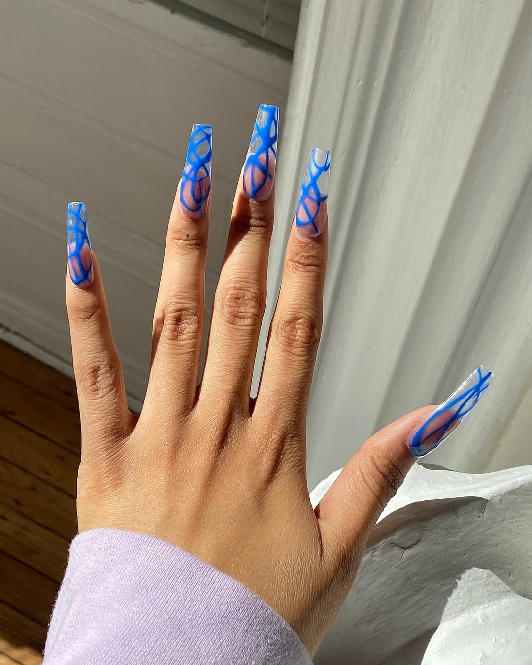 long clear coffin nails with blue nail art