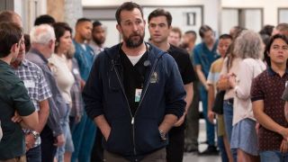 Noah Wyle walking down a hallway with Patrick Ball behind him in The Pitt.