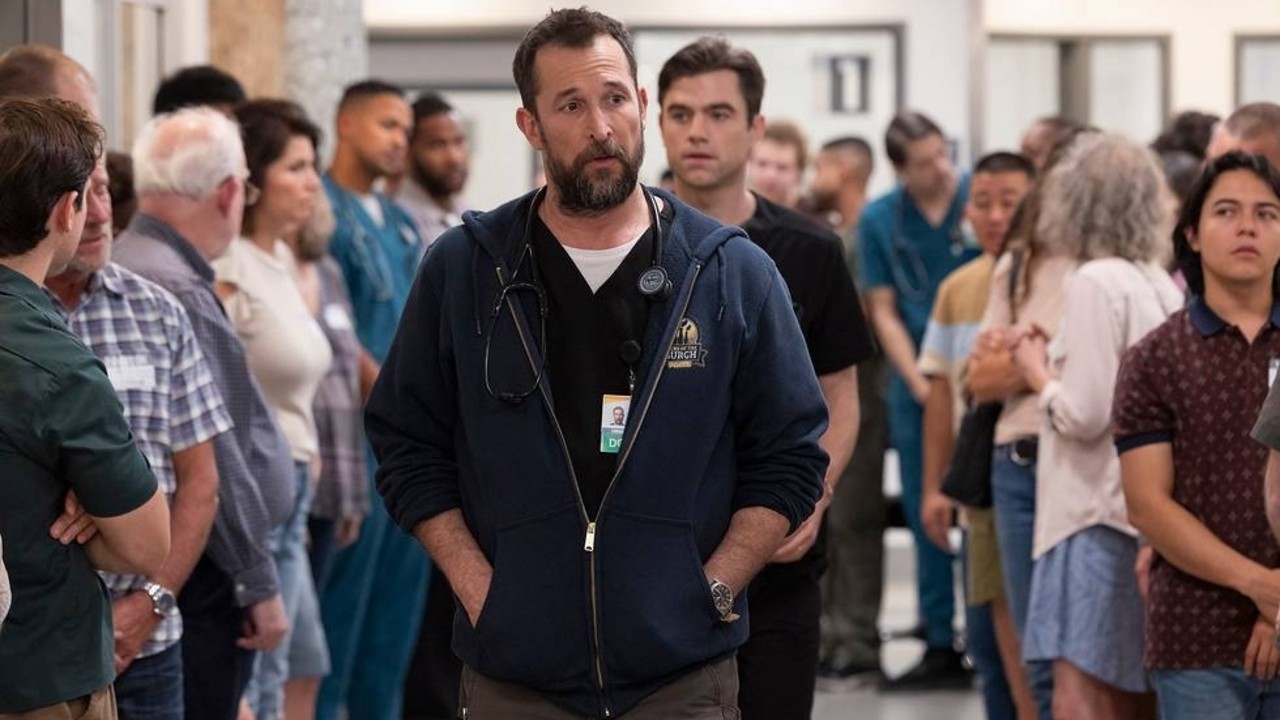 Noah Wyle walking down a hallway with Patrick Ball behind him in The Pitt.