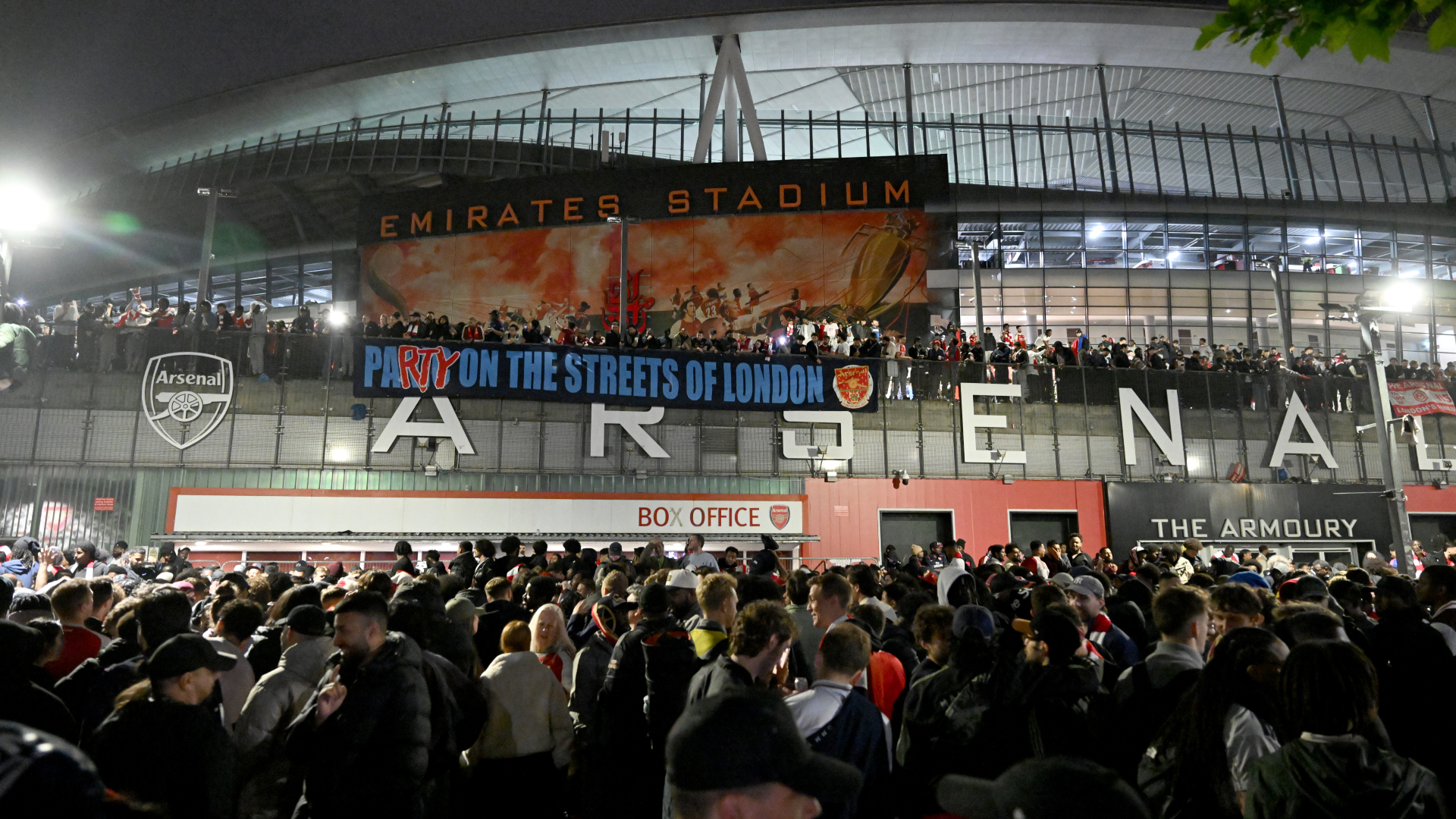 Arsenal fans celebrate their team winning the Premier League at Emirates Stadium
