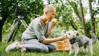 Woman having a picnic with her dog