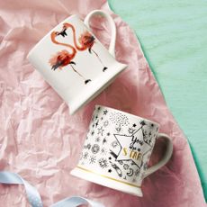 white mugs with flamingo design and quote