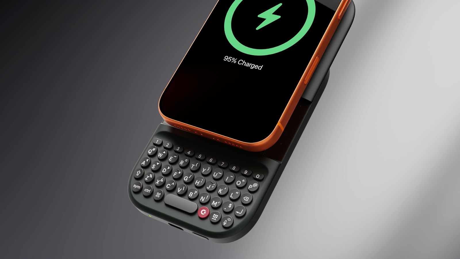 A Clicks Power Keyboard attached to a phone on a grey background.