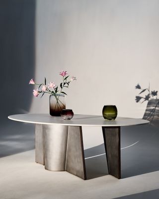 a table with vases from CB2 in a white room