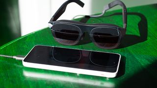 A pair of Xreal One glasses hooked up to an Xreal Beam Pro