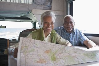 Couple reading a map in RV.