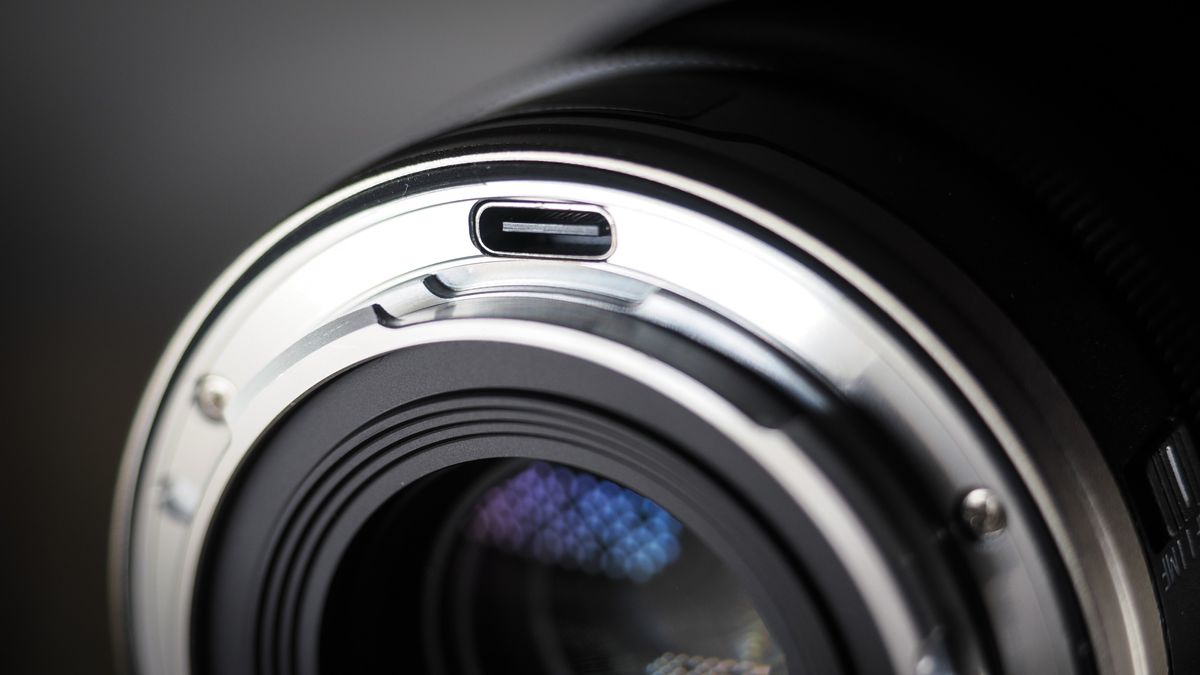 7Artisans AF 10mm f/2.5 Fisheye Max lens on a wooden surface