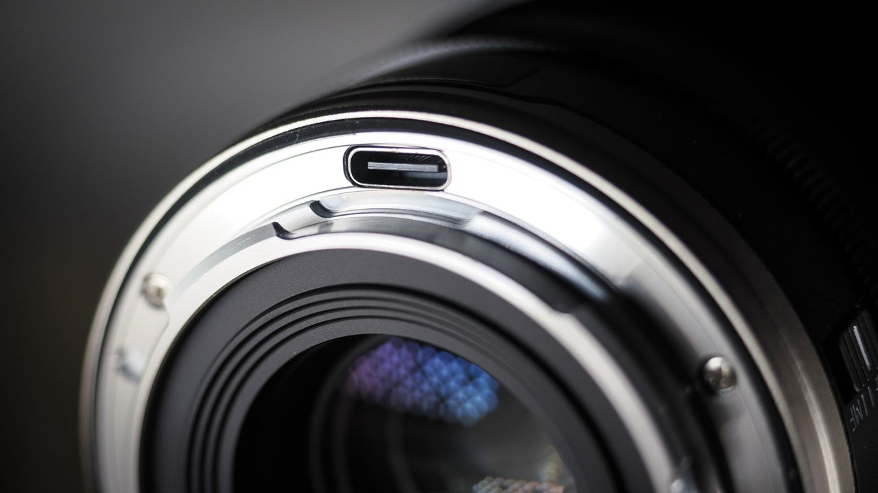 7Artisans AF 10mm f/2.5 Fisheye Max lens on a wooden surface