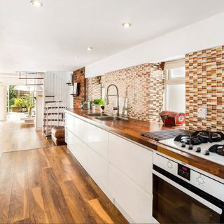 kitchen room with wooden flooring and kitchen worktops