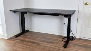 The Secretlab Magnus Evo standing desk up against a wall