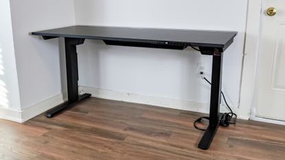 The Secretlab Magnus Evo standing desk up against a wall