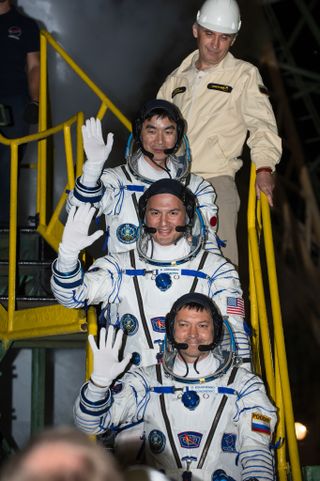 A new crew for the International Space Station waves farewell to friends and family before launching into space from Baikonur Cosmodrome in Kazakhstan on July 22, 2015. They are (from top): astronaut Kimiya Yui of the Japan Aerospace Exploration Agency; NASA astronaut Kjell Lindgren; and cosmonaut Oleg Kononenko.