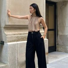 Influencer wears a halterneck blouse.