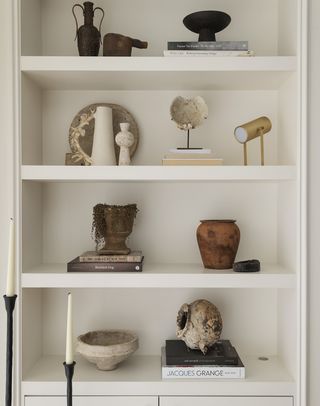 living room shelving filled with objets