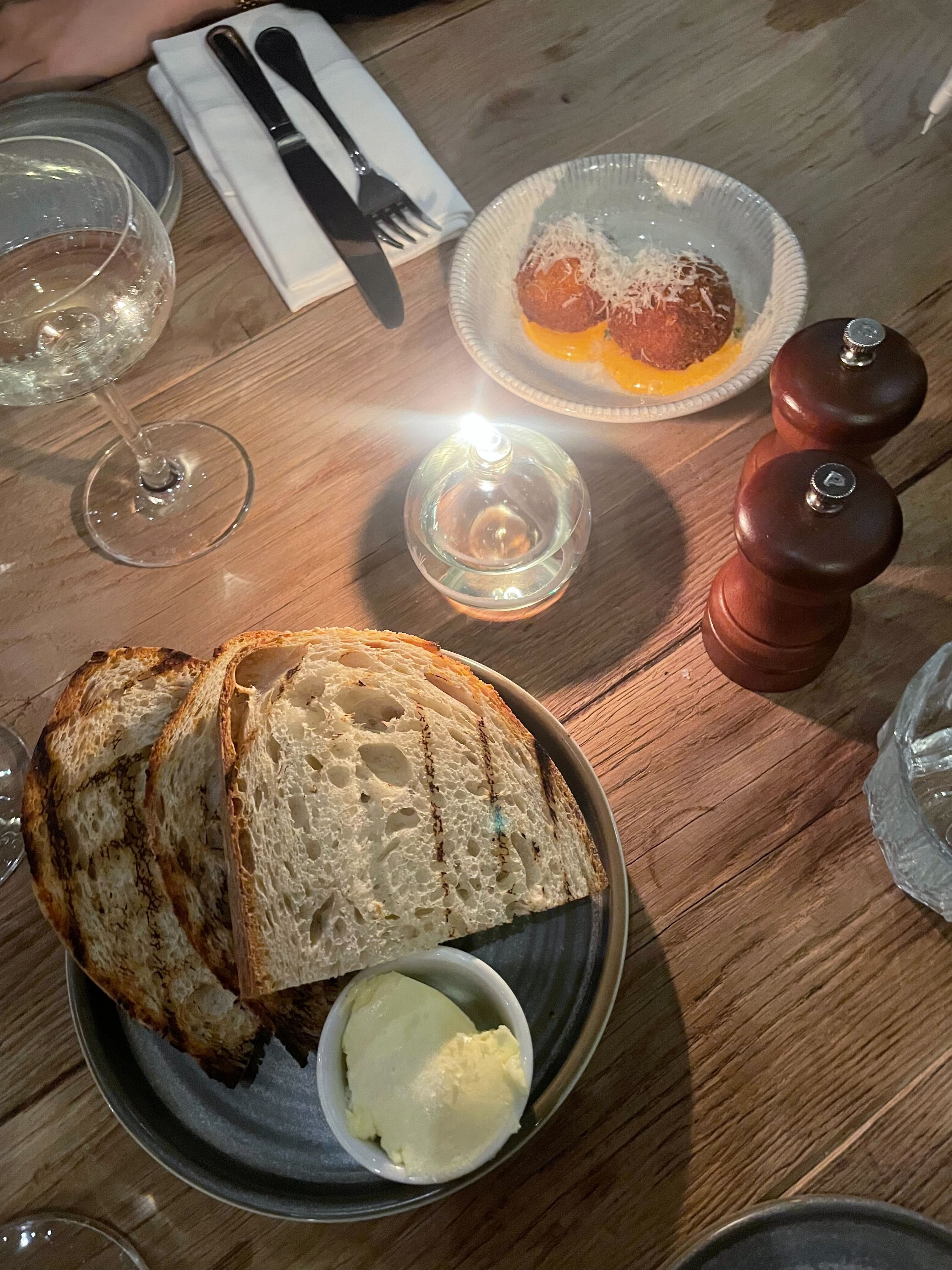 an image of the bread and the arancini at the brook and badger